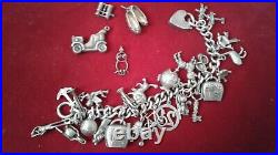 VINTAGE SOLID STERLING SILVER CHARM BRACELET 29 CHARMS. CHUNKY 76.8 grams