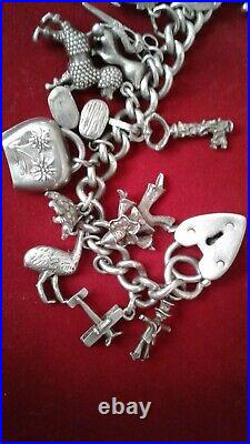 VINTAGE SOLID STERLING SILVER CHARM BRACELET 29 CHARMS. CHUNKY 76.8 grams